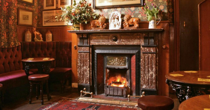 View of the famous Historic Pub interior of The Victoria Inn, Durham City - seating area with open fire in Victorian style.